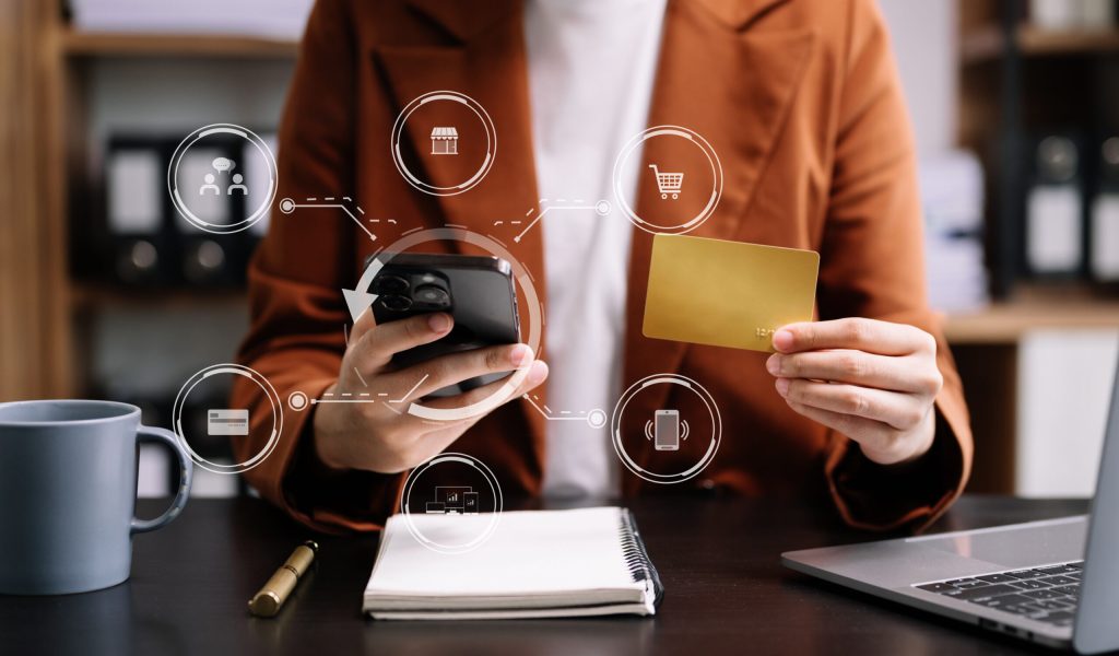 A young adult holding a smartphone and credit card with digital banking icons, representing Gen Z's preference for mobile-first financial services.